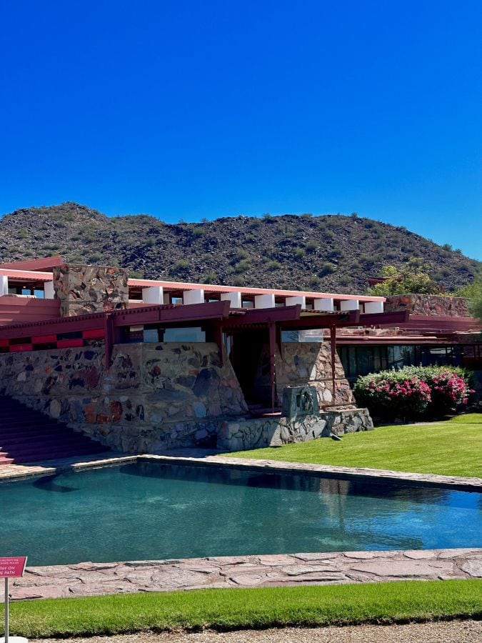 Scottsdale Frank Lloyd Wright Home, Taliesen West with refelction pool and mountain view under clear blue sky.